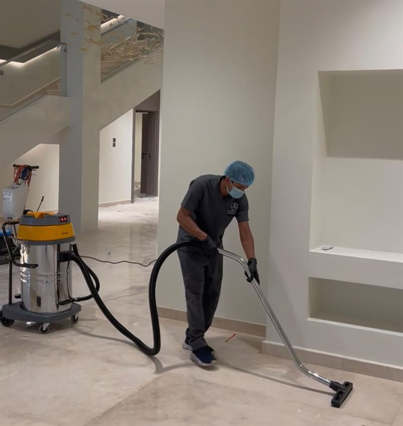 Deep Clean technician vacuuming inside a villa